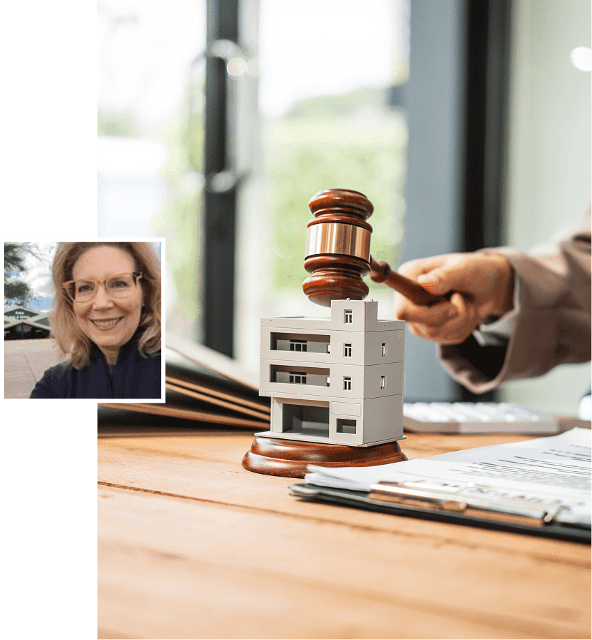 Gavel striking near miniature building model.